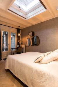 a bedroom with a large bed and a skylight at B&B Felix in Amsterdam