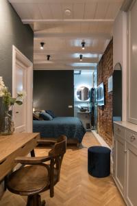 a bedroom with a bed and a table and chairs at B&B Felix in Amsterdam