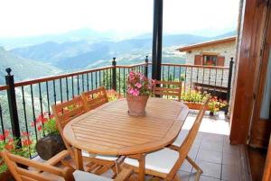 a wooden table with a potted plant on a balcony at Paller Cal Cintet in Aristot