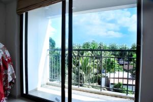 a window in a room with a view of a balcony at Krishna Dhwani Apartments in Tellicherry