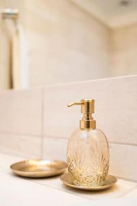 a soap dispenser on a counter in a bathroom at Chic Penthouse Grand-Place in Brussels