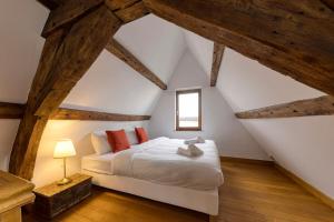 a bedroom with a bed in an attic at Chic Penthouse Grand-Place in Brussels