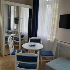 a small table and chairs in a room with a table and chairsktop at Apartman Orgona in Siófok