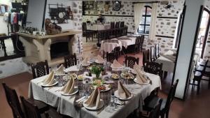 a dining room with a long table with plates and napkins at Hotel Bolyarka in Melnik