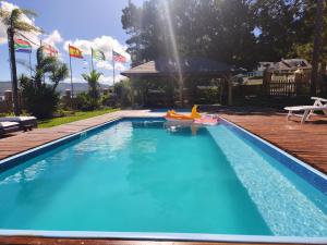 a large swimming pool with a raft and a float in it at Lagoon Breeze Guest House in Knysna