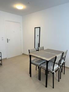 a table and chairs in an empty room at Appartement - Tournan en Brie a 20min de Disneyland in Tournan-en-Brie