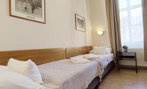 Posteľ alebo postele v izbe v ubytovaní Budapest Csaszar Hotel