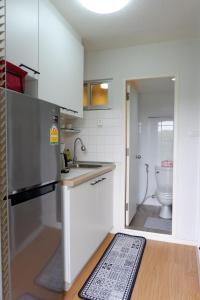 a small kitchen with a sink and a toilet at AnnaHome122@Latkrabang in Ban Khlong Prawet