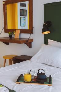 a tray with a tea set on a bed at Limon Inn Hotel, Taşucu in Tasucu