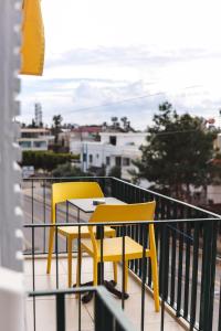 two yellow chairs and a table on a balcony at Limon Inn Hotel, Taşucu in Tasucu