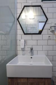 a white sink in a bathroom with a mirror at Limon Inn Hotel, Taşucu in Tasucu
