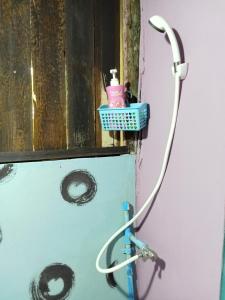 a bathroom with a hose hooked up to a wall at peaceland farmstay in Ban Mai (1)
