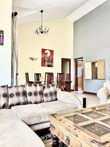 a living room with a couch and a table at Westlands Escape-Homestay in Nairobi