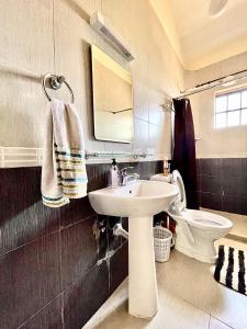 a bathroom with a sink and a toilet at Westlands Escape-Homestay in Nairobi