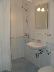 a bathroom with a sink and a toilet and a mirror at Apart Hotel Kasandra in Sunny Beach