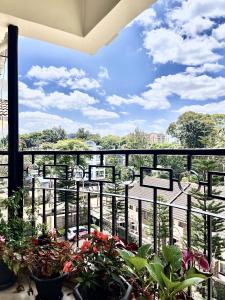 a balcony with potted plants and a view at Westlands Escape-Homestay in Nairobi
