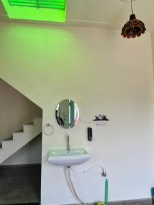 a bathroom with a sink and a mirror on the wall at Kashi Village Home Stay in Varanasi