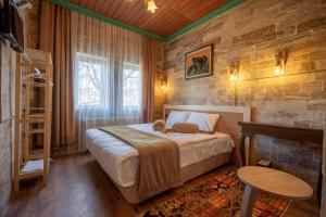 a bedroom with a bed with a teddy bear on it at ARTON İN CAPPADOCİA HOTEL in Avanos