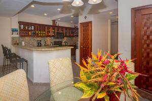 a kitchen with a table and chairs and a counter at Lawson Rock - Angelfish 201 condo in Roatan