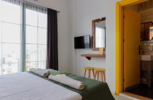 a bedroom with a bed with two towels on it at Limon Inn Hotel, Taşucu in Tasucu