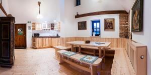 a kitchen with a wooden table and a table and chairs at Ekofarma Polná in Hazlov