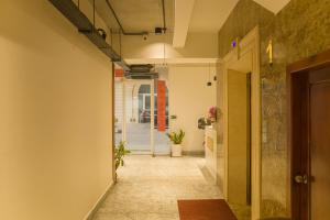 a hallway with a door leading into a room at Try Residence, The Elysée Koh Pich in Phnom Penh