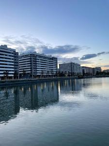 a large body of water with buildings in the background at MODERN BILBAO in Barakaldo