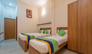Postel nebo postele na pokoji v ubytování Itsy Hotels Avani Stays, Vyttila, Kochi + 26 fotografií