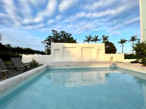 a swimming pool in front of a building at An Blue House in Dazhou