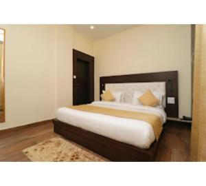 a bedroom with a large bed in a room at Hotel Mirage Residency in Dharamshala