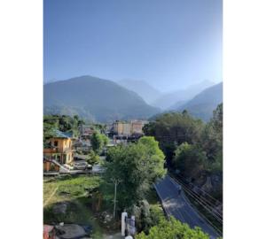 a view of a town with mountains in the background at Hotel Mirage Residency in Dharamshala