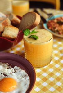 a table with a plate of food and a drink at Limon Inn Hotel, Taşucu in Tasucu