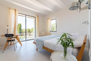 a bedroom with a bed and a table and a desk at Casale Valverde in Alghero