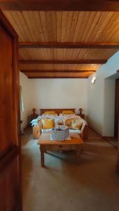 a bedroom with a large bed with a wooden ceiling at Apartmán Stodola in Malá Morávka