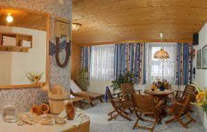 a dining room with a table and chairs in a room at Landhotel Almrösl im Großarltal in Hüttschlag