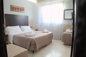 Postel nebo postele na pokoji v ubytování Hotel Dei Tartari