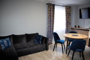 a living room with a couch and a table at Motel Paradise in Torzym