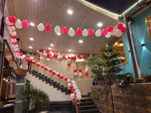 a staircase with red and white balloons and a christmas tree at Goroomgo Hidden Chalet Mall Road Nainital Near Naini Lake in Nainital