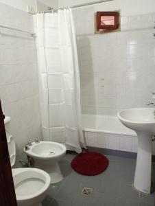 a bathroom with a toilet and a sink and a shower at Casa Alfonso I in Humahuaca