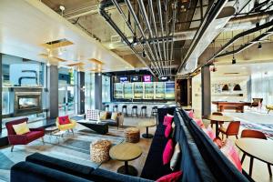 a lobby with a couch and chairs and tables at Aloft Nashville Franklin in Franklin