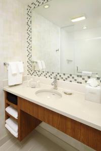 a bathroom with a sink and a large mirror at SpringHill Suites Houston Intercontinental Airport in Houston