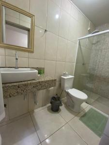 a bathroom with a sink and a toilet and a shower at Hotel Ferrari in Rio do Sul