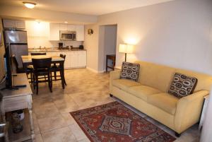 a living room with a couch and a kitchen at Days Inn by Wyndham Cocoa Cruiseport West At I-95/524 in Cocoa