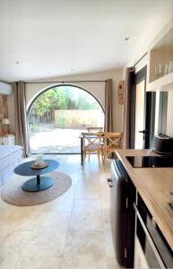 a kitchen and living room with a table in a caravan at Villa La Carpenée in Roquefort-les-Pins