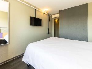 Postel nebo postele na pokoji v ubytování ibis Vesoul