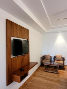 A television and/or entertainment centre at Marutham Residency