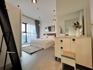a bedroom with a bed and a large mirror at 1BR Americana Apartment: Stars and Stripes Haven in Abu Dhabi
