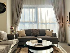 a living room with a couch and a coffee table at 1BR Americana Apartment: Stars and Stripes Haven in Abu Dhabi