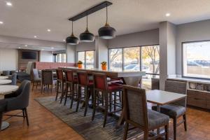 a restaurant with a bar with chairs and tables at Hampton Inn Athens in Athens