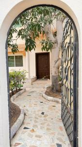 an entrance to a house with an iron gate at Chic 3-BR Tala Almajd Villas in upscale district Alnahdah Family only in Jeddah